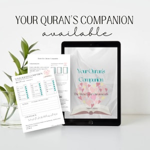 May include: A digital tablet displaying a pink and white book cover with the text "Your Quran's Companion The Friend Your Quran Needs" and a heart design with pink and white hearts. The tablet is on a white surface next to a printed page with the text "Your Quran's Companion" and a grid of squares.