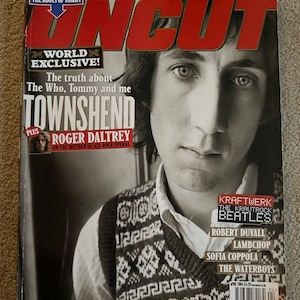 May include: A magazine cover featuring a black and white photo of Roger Daltrey, the lead singer of The Who, with the title "The truth about The Who, Tommy and me TOWNSHEND" and the text "WORLD EXCLUSIVE!" in red. The magazine is called "Uncut" and has a free CD offer for "The Roots of Tommy".