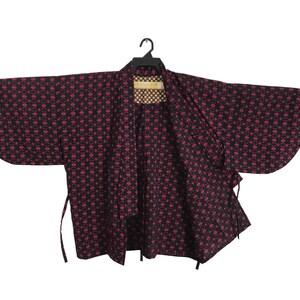 May include: A black and pink patterned kimono with a tie closure. The kimono has a traditional Japanese design.