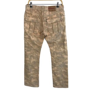 May include: Beige camouflage print pants with a brown leather patch on the back.