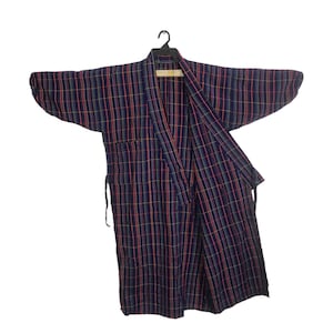 May include: A navy blue plaid robe with a colourful grid pattern of red, yellow, and green lines. The robe is hanging on a black hanger and has a wrap-around design with a waist tie.