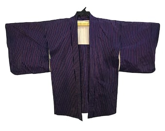 May include: A dark purple kimono with vertical white stripes. The traditional Japanese garment is open in the front and has wide sleeves. The kimono is hanging on a black hanger against a white background.
