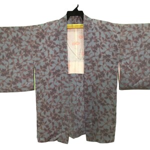 May include: A blue and purple patterned Japanese kimono with a floral design.