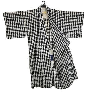 May include: A black and white diamond-patterned kimono hangs from a black hanger. The garment has long sleeves and a small tag with text visible on the inside. The kimono is a traditional Japanese garment.