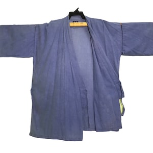 May include: A blue cotton kimono with a long, open front and long sleeves. The kimono has a simple design and is made of a lightweight fabric.