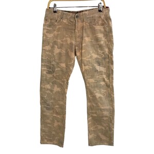May include: A pair of camouflage-patterned jeans in a light brown color. The jeans have a straight leg and a relaxed fit.