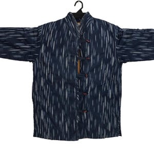 May include: A navy blue jacket with a vertical white stripe pattern. The jacket has long sleeves and a mandarin collar. It features wooden toggle closures down the front and is displayed on a black hanger.