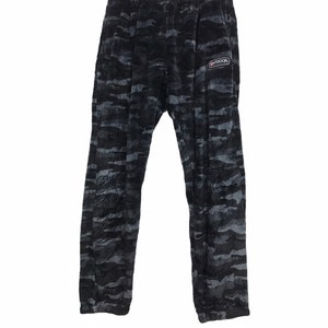 May include: Black and grey camouflage print sweatpants with a small white logo that says "OUTDOOR" on the right leg.