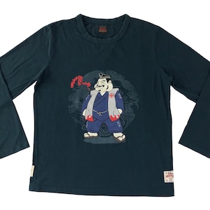 May include: A dark blue long-sleeved t-shirt featuring a graphic print of a cartoon character in a traditional Japanese outfit. The character is surrounded by floral and dragon designs.