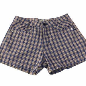 May include: Blue, tan, and red plaid shorts with two front pockets and a button closure. The shorts have a classic design and are made of a lightweight fabric. The shorts are suitable for casual wear.