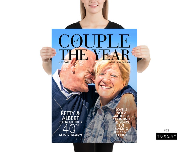 May include: A magazine cover with a photo of an older couple smiling and hugging. The headline reads "Couple of the Year" with the date "5.11.2021" and the text "Love is in the air". The text below the photo reads "Betty & Albert Celebrate their 40th Anniversary!" and "Love is not a matter of counting the years, but making the years count". The magazine cover is 18 inches by 24 inches.