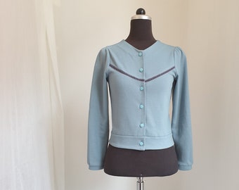 Cardigan, size 34, made of dove blue BW, with puffed sleeves, applied grey velvet ribbons, original Bohemian glass buttons from the 30s