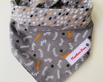 Reversible Cat Bandana with paw prints, kitty, play, meow and prrrr on the front side and coordinating coloured ovals on the reverse side.