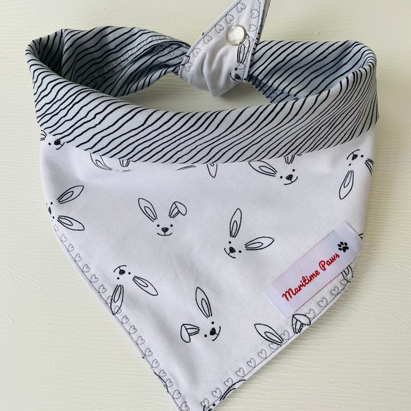 Reversible Easter Bunny Bandana for dogs or cats.  White with cute black bunny faces on front side.  Reverse is grey with black lines.
