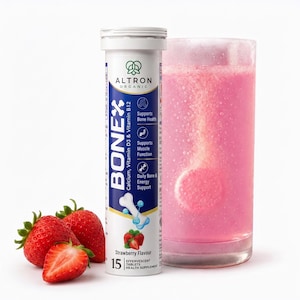 May include: A white cylindrical tube of Altron Organic Bonex effervescent tablets with blue and gold branding, next to a glass of pink liquid with a dissolving tablet and three fresh red strawberries with green stems on a white background.
