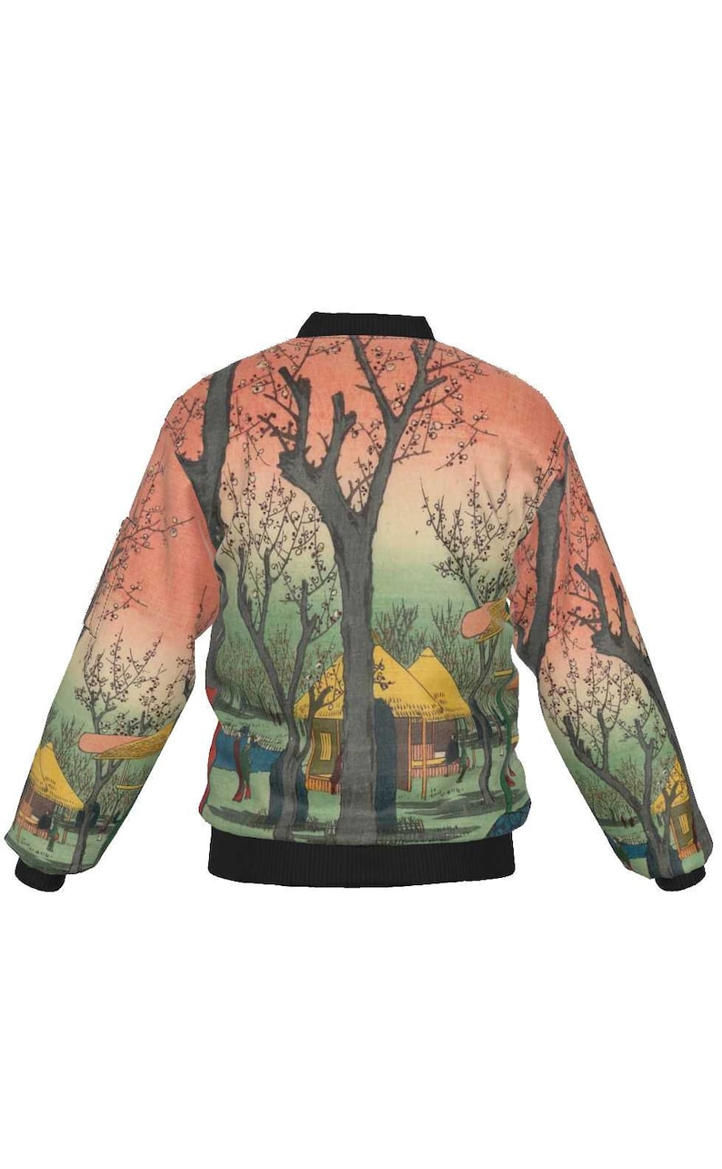 May include: A bomber jacket featuring a Japanese landscape design. The jacket has a black collar, cuffs, and hem. The artwork depicts trees, buildings, and figures in shades of green, orange, and black.