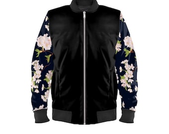 May include: Black bomber jacket with a full-length zipper. The sleeves feature a dark blue floral pattern with white and pink blossoms. The jacket has a ribbed collar, cuffs, and hem.