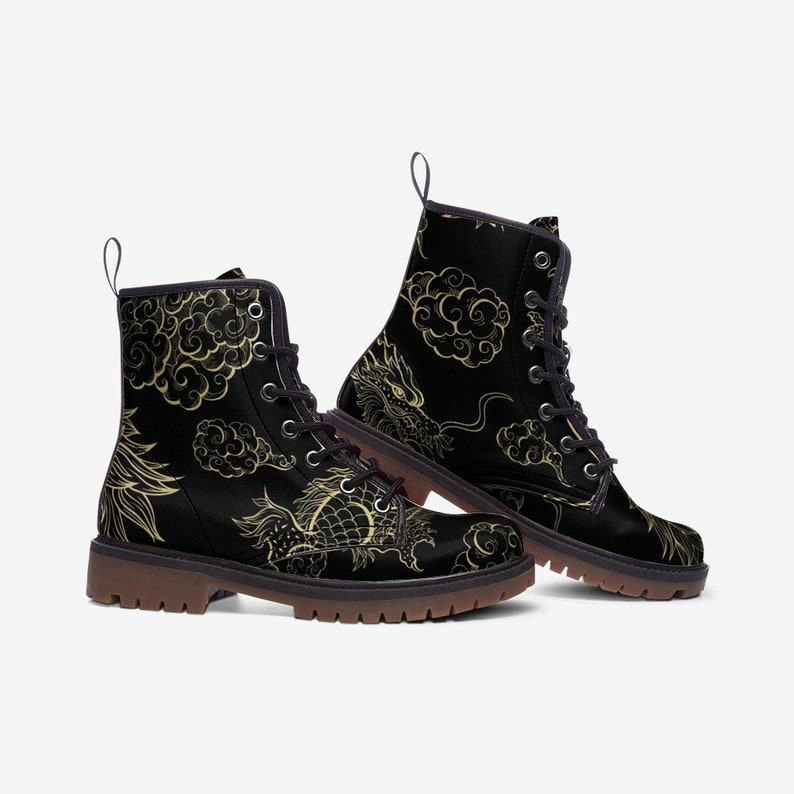 Puede incluir: Botas de combate negras con un dise&ntilde;o de drag&oacute;n y nubes doradas. Las botas tienen cierre de cordones, una leng&uuml;eta y suela marr&oacute;n. El dise&ntilde;o de drag&oacute;n y nubes cubre toda la bota.
