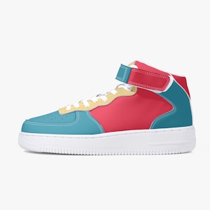 May include: High-top trainer in a vibrant colour block design. The shoe features a teal toe, red midsection, and teal and red accents. A yellow strip runs along the laces, and a white sole completes the look. The shoe has a velcro strap.