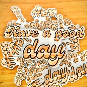 May include: A collection of stickers with a woodgrain pattern and black outlines. The stickers feature the phrase "Have a good day" in a bold, stylized font.