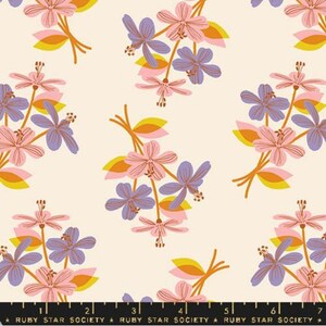 May include: A white fabric with a repeating pattern of pink, purple, and yellow flowers. The flowers are stylized and have a retro feel.