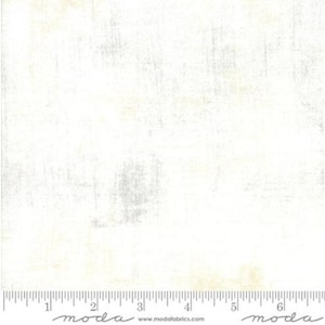 May include: White fabric with a subtle, distressed texture. The fabric has a slightly off-white color with hints of gray and beige. The fabric is perfect for quilting, crafts, and home decor projects.
