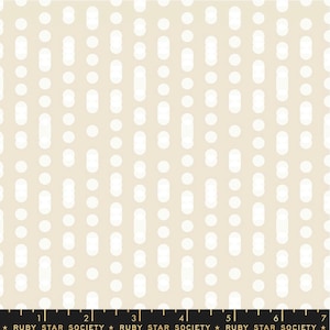 May include: A beige fabric with a white repeating pattern of circles and ovals. The pattern is reminiscent of a dotted swiss fabric.