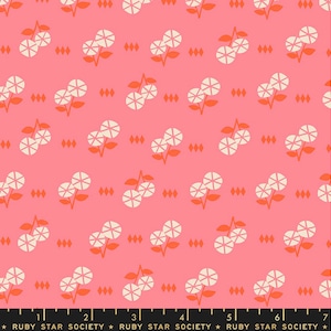 May include: A pink fabric with a repeating pattern of white flowers with orange centers. The flowers are arranged in pairs with a small diamond shape between each pair. The fabric has a subtle texture.