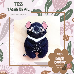 May include: A hand-sewn pattern for a black and white Tasmanian devil plush toy. The pattern is part of the "Bush Buddy" series and is numbered 4. The pattern is illustrated with a cute cartoon Tasmanian devil with pink ears and a white collar.