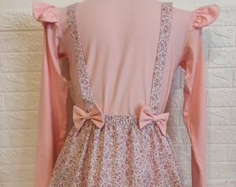 ABDL. Long-sleeved pink bodysuit with floral skirt.
