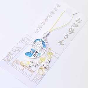 May include: A silver charm with a blue and white enamel design of a temple. The charm is attached to a yellow string with small yellow beads and a silver charm with a heart design. The charm is labeled "Ise Shrine" in Japanese characters.