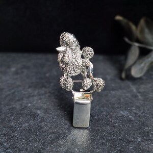 Può includere: Broche a forma di barboncino in argento con un design dettagliato. La broche è fissata a una clip in argento.