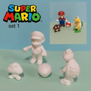 May include: White plastic figurines of Super Mario characters, including Mario, a turtle, and a mushroom. The set is labeled "Super Mario set 1".