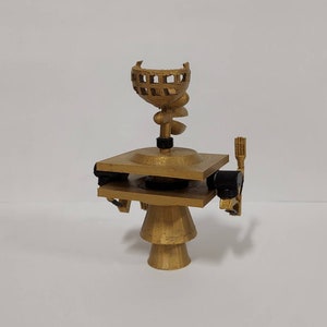 May include: A gold-colored 3D printed model of a satellite with a dish antenna and a rotating arm. The model is on a white background.