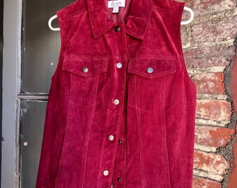 May include: A burgundy suede vest with a button-up front and two flap pockets. The vest has a D.C.Co. label.