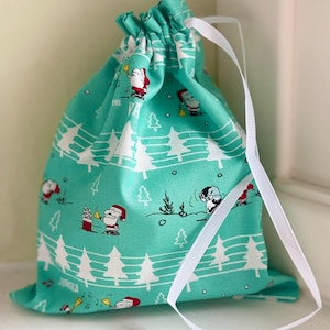 Türkis-blaue Snoopy Peanuts Weihnachtsmusik Druck Kordelzugbeutel