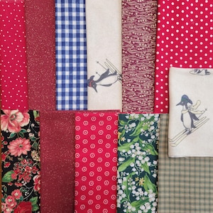 May include: A collection of various fabric swatches in red, blue, and green. Patterns include polka dots, gingham, floral, and a penguin skiing design. The fabrics are arranged in a grid, showcasing a variety of textures and prints.