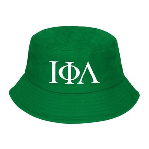 May include: A green bucket hat with the Greek letters "IΦA" in white.