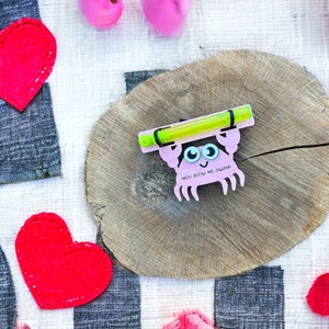May include: Pink and green crab-shaped card with the text "You blow me away" and a green bubble wand attached to the top.