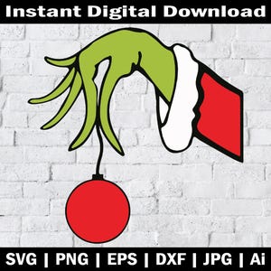 May include: A green hand with a red and white sleeve holding a red Christmas ornament. The hand is reaching down to hang the ornament.