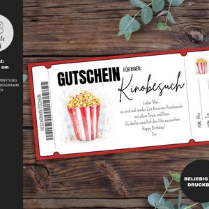 May include: A red and white printable gift certificate for a movie ticket. The certificate features a watercolor illustration of a bucket of popcorn. The text on the certificate reads "Gutschein f&uuml;r einen Kinobesuch".
