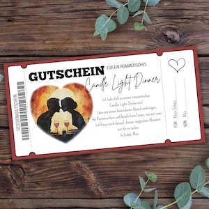 May include: A red and white gift voucher for a romantic candlelit dinner. The voucher features a watercolour illustration of a couple enjoying a glass of wine together. The text reads "Gutschein für ein romantisches Candle Light Dinner".
