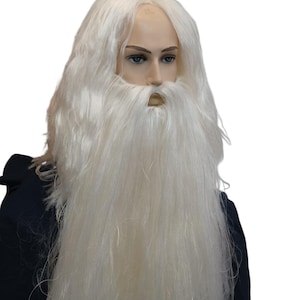 May include: A long white wig and matching long white beard set displayed on a mannequin head. The wig features straight, shoulder-length hair, while the beard is thick and reaches down to the chest area, covering the chin and mouth region.