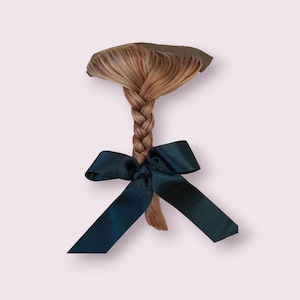 May include: A long braid of blonde and red hair with a dark blue ribbon tied at the end.