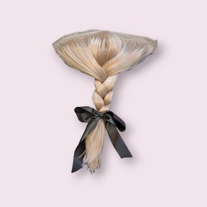 May include: A blonde braid with a black ribbon tied at the end. The braid is styled with a straight, smooth texture.
