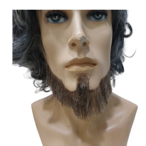 May include: A brown and gray fake beard with a mustache on a mannequin head.