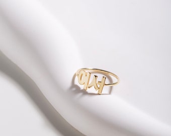 May include: Gold ring with the word "LOVE" written in Korean characters.