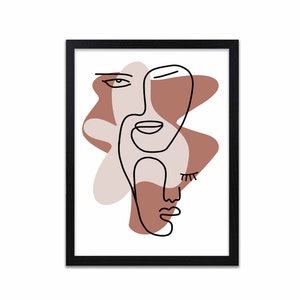 Puede incluir: Impresión de arte de línea abstracta de dos caras con formas marrones y rosadas, enmarcada en negro.