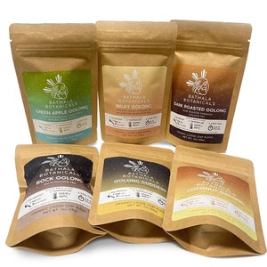 May include: Six brown paper pouches with labels containing different varieties of oolong tea. The labels feature a stylized illustration of a woman with a teacup and the text "Bathala Botanicals". The tea varieties are Green Apple Oolong, Milky Oolong, Dark Roasted Oolong, Rock Oolong, Oolong Goddess, and Coconut Oolong.