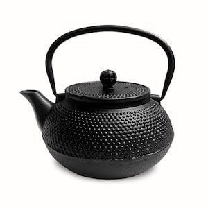May include: Black cast iron teapot with a textured, dimpled surface and a black lid with a knob on top.